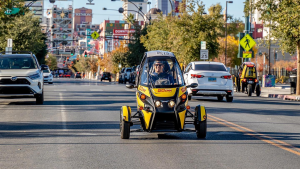 man in a gocar driving down the street
